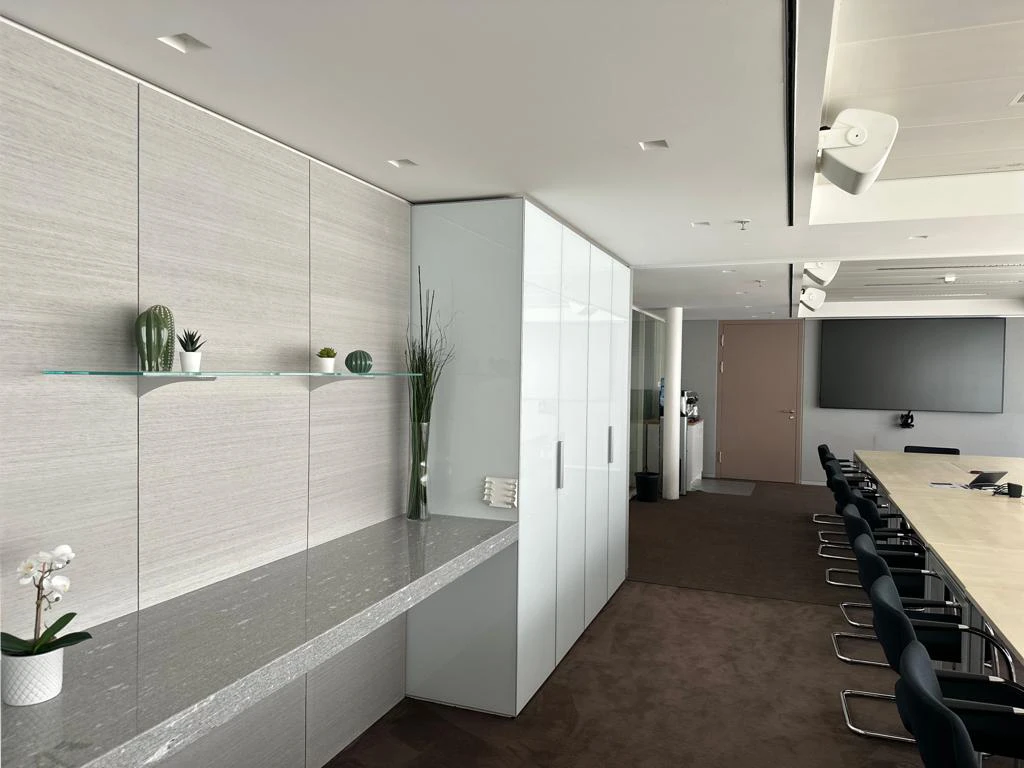 Modern conference room with built-in cabinetry and granite surfaces