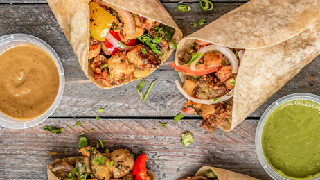 Colorful wraps and burritos with sauces